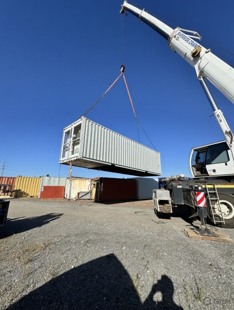 A Green Racks data-centre container being lifted into place by crane