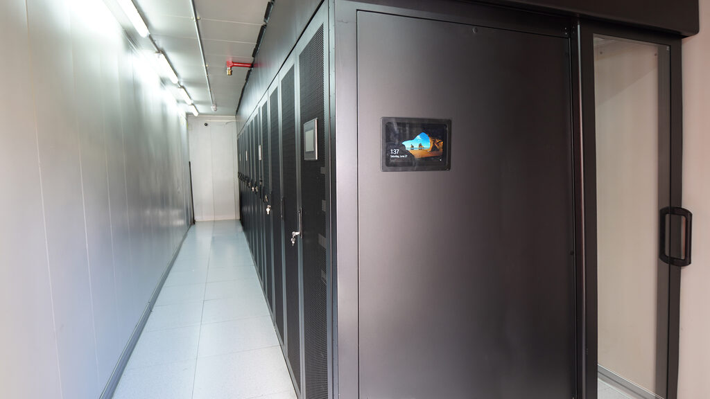 Secure cold aisle of black server cabinets inside our Australian colocation data centre