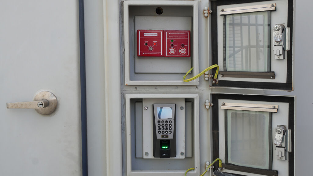 Manual fire suppression switch and biometric reader at a secured data centre entry point