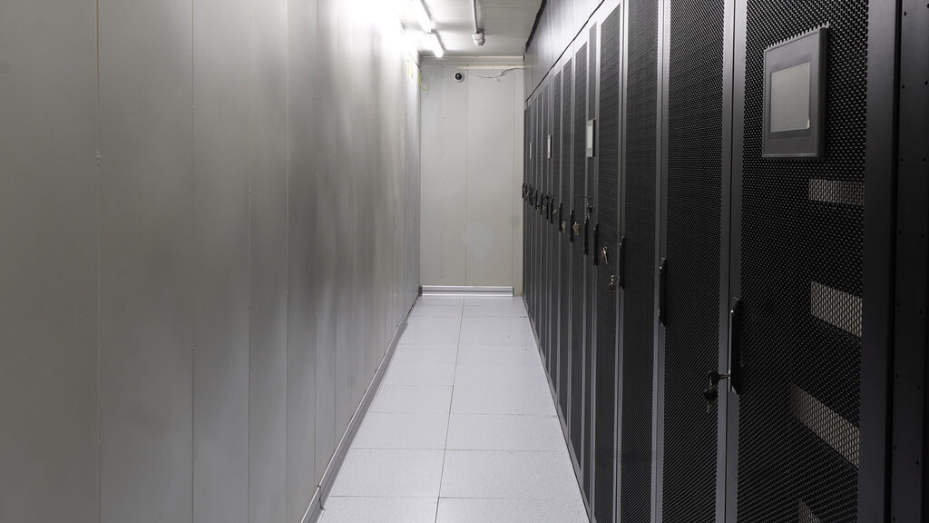 Cold aisle containment corridor lined with locked server racks at our Australian data centre