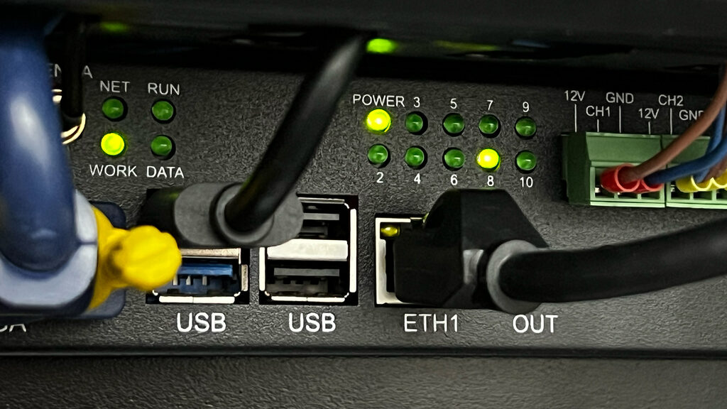 Industrial monitoring gateway with status LEDs and Ethernet ports inside a colocation rack